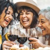 a group of friends laughing drinking wine