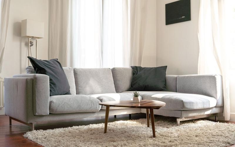 oversized windows brighten spacious, furnished living room